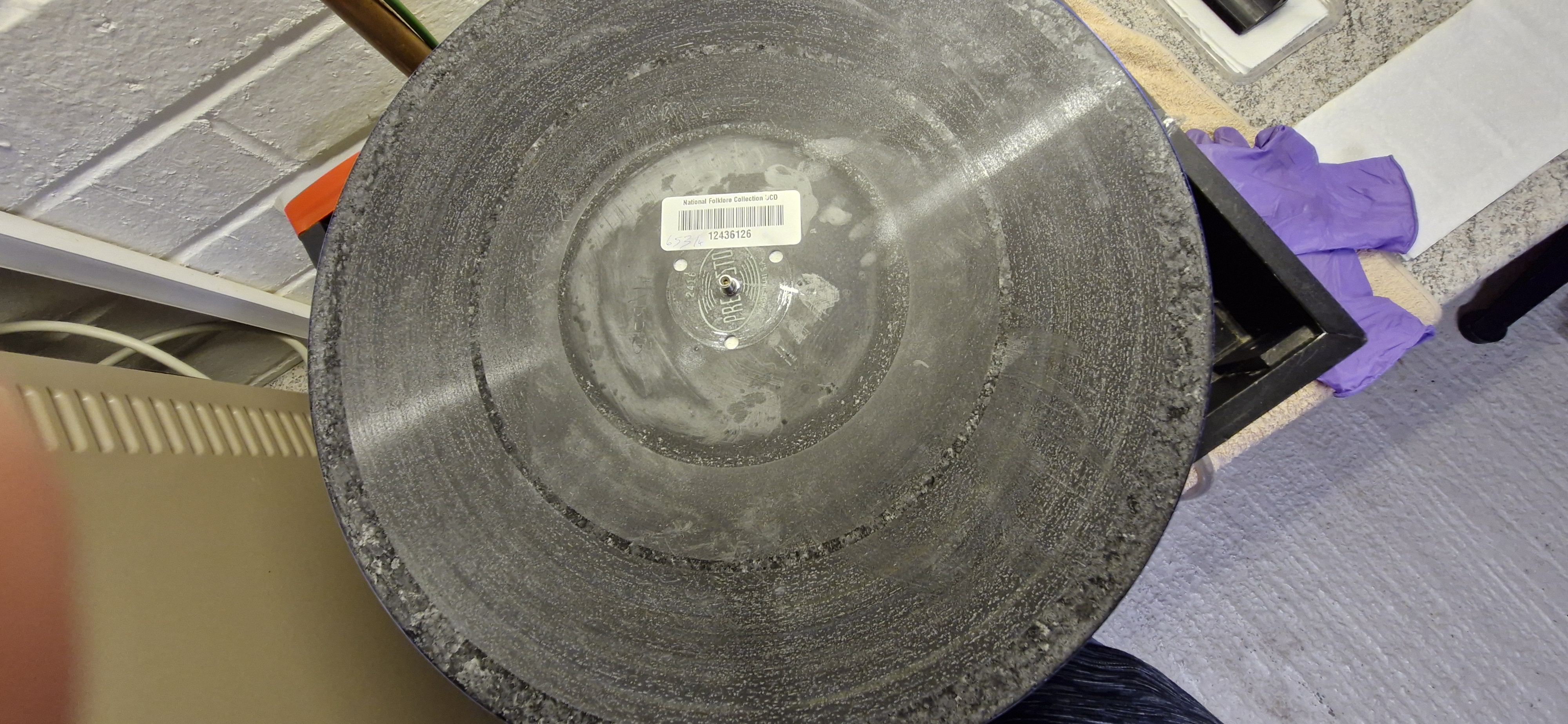 White palmitic acid residue visible on an acetate disc